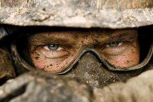 A man in a helmet and goggles looks into the camera photo