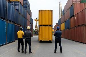 Three men standing in front of a container photo