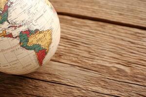 A globe sitting on a wooden table photo