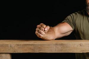 A man with a beard and a beard sitting at a table photo