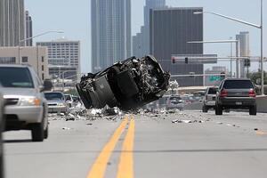 A car that has crashed into the side of a building photo