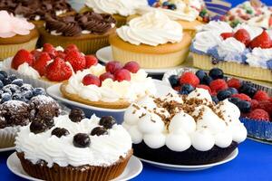 A table with many different types of cakes and desserts photo