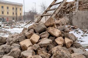 A pile of rubble and a ladder in front of a building photo