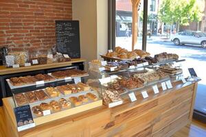 A bakery counter with many different types of pastries photo