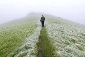 A man walking on a path in the fog photo