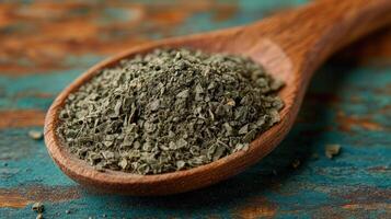 Dried herb spoon rustic wood background cooking photo