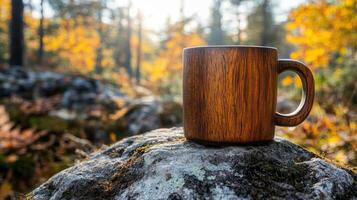 Wooden mug rests on a mossy rock in a sun-dappled autumn forest photo