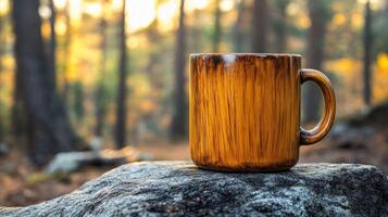 Wooden mug rests on a rock in a sunlit forest photo