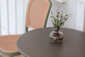 The flowers in the vase add a touch of elegance to the table. photo