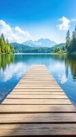 wooden pier extends into tranquil lake with mountains in background photo