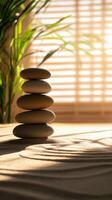 Smooth stones stacked in zen garden with sand patterns photo