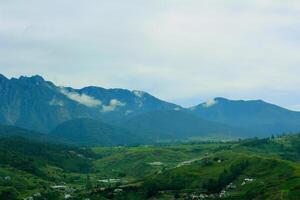 Scenic Mountain Landscape with Green Valleys and Misty Peaks in Kundasang, Borneo photo