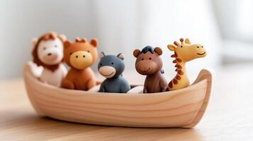 Noah's ark or wooden boat with five toy animal figurines including lion and giraffe photo