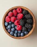 Wooden bowl filled with fresh organic berries promoting a healthy and balanced diet photo
