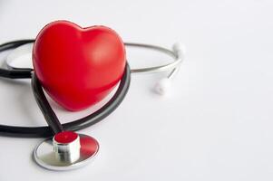 Close up view of stethoscope and a red heart shaped with customizable space for text. Medical and health concept photo