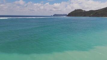 Waves rolling over coral reefs in turquoise waters of Lombok video