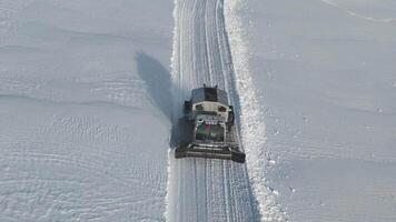 Overhead view of snowcat creating path through deep snow video