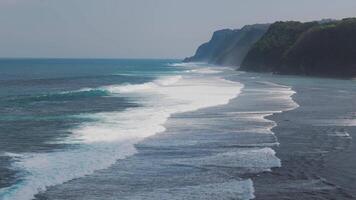 Aerial view of Bali's coastal cliffs with waves crashing below video