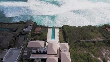 Aerial view of a luxurious villa with an infinity pool facing the ocean video