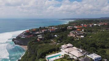 Aerial view of luxurious villas on the cliffs of Bali's coastline video