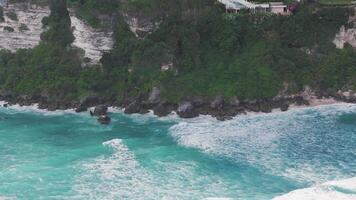 Clifftop resort with ocean waves crashing below in Bali, Indonesia video