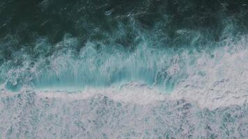 Aerial close-up of ocean surface with swirling waves and foam video