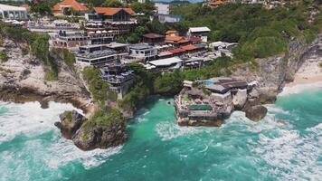 Aerial view of a cliffside resort with ocean waves crashing below video