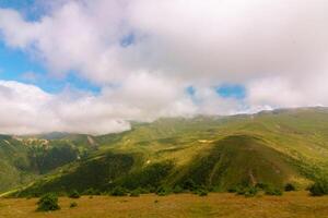 Rolling clouds over the highland mountains in the summer photo
