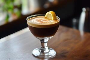 A coffee drink with a lemon wedge on top photo