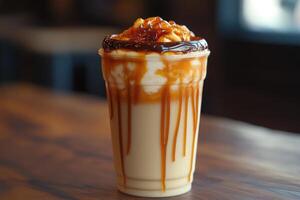 A caramel latte with caramel drizzle on top photo