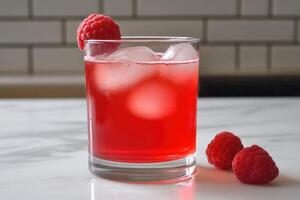A glass of raspberry drink with ice and raspberries photo