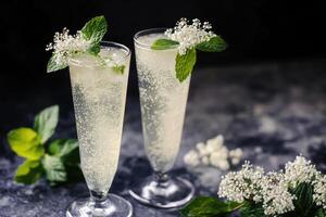 Two glasses of white wine with mint leaves photo