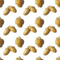 Autumn seamless pattern with golden painted acorns oak tree isolated on white background. Autumnal Still life image with natural materials. Autumn, fall concept. Repeat print top view, sunlight photo