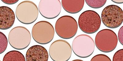 Colorful Swatches eyeshadow refills as minimal geometric pattern, banner. Matte, glitter pans red brown pink shade with shadows, detailed texture, cosmetic, beauty product, make up, warm color scheme photo