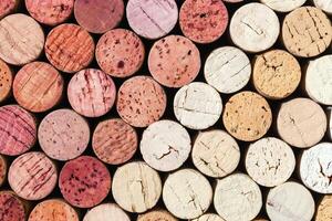 Collection of wine cork from white and red wine, natural texture bottle stoppers top view, colorful background from closeup wooden corks. Natural textured stoppers Winery, winemaking concept photo