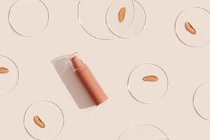 Cosmetic product, bottle of makeup foundation cream, cosmetics swatches nude color on glass disks on beige background. Beauty product mock up, package concealer base container photo