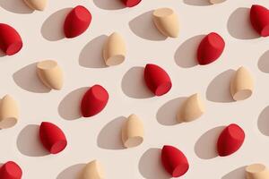 Trend pattern from makeup sponges beige and red colored for foundation cream on beige color background with shadows from sunlight. Geometric flat lay beauty blender, cosmetic sponge, make up puff photo