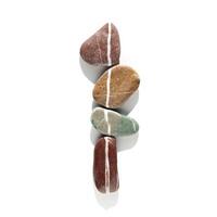 Creative arrangement of natural color stones. Smooth pebbles in row isolated on white background. Minimal trend summer flat lay, top view still life with bright sea pebble on the same line photo