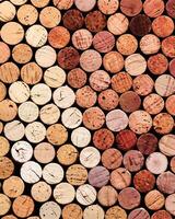 Collection of wine cork from white and red wine, natural texture bottle stoppers top view, colorful background from wooden corks. Natural textured stoppers colored. Winery, winemaking concept photo