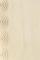 Top view pattern in Japanese Zen Garden with close up concentric circles on sand for meditation and relaxation. Aesthetic minimal sand background with copyspace, beige neutral tones. photo