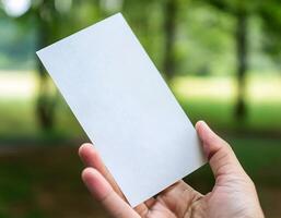Close-Up of Hand Holding Empty Sheet of Paper photo