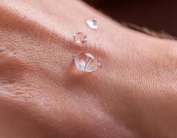 Close-Up of Hand with Clear Collagen Drops photo