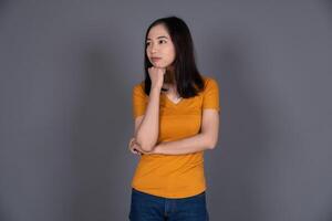 Portrait of a Young Girl Thinking, Looking Confused and Pensive Isolated photo