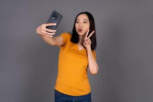 Close-Up of a Female Smiling Happily While Taking a Selfie Isolated Background photo