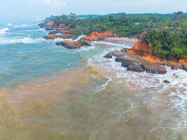 An aerial view of the ocean and red cliffs photo