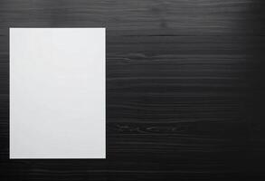 Empty or Blank white A4 paper, Vertical paper with copy space, on black wooden background photo