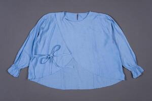 Light Sky Blouse Against a Grey Background photo