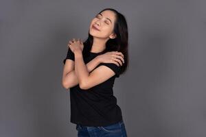 Portrait of a Girl Hugging Herself, Smiling with Self-Love and Happiness Isolated Background photo