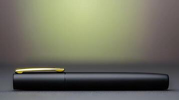 Sleek black pen resting on a smooth surface with a blurred gradient background photo