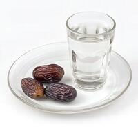 Glass of Water and Dates on Plate Ramadan Iftar Meal photo